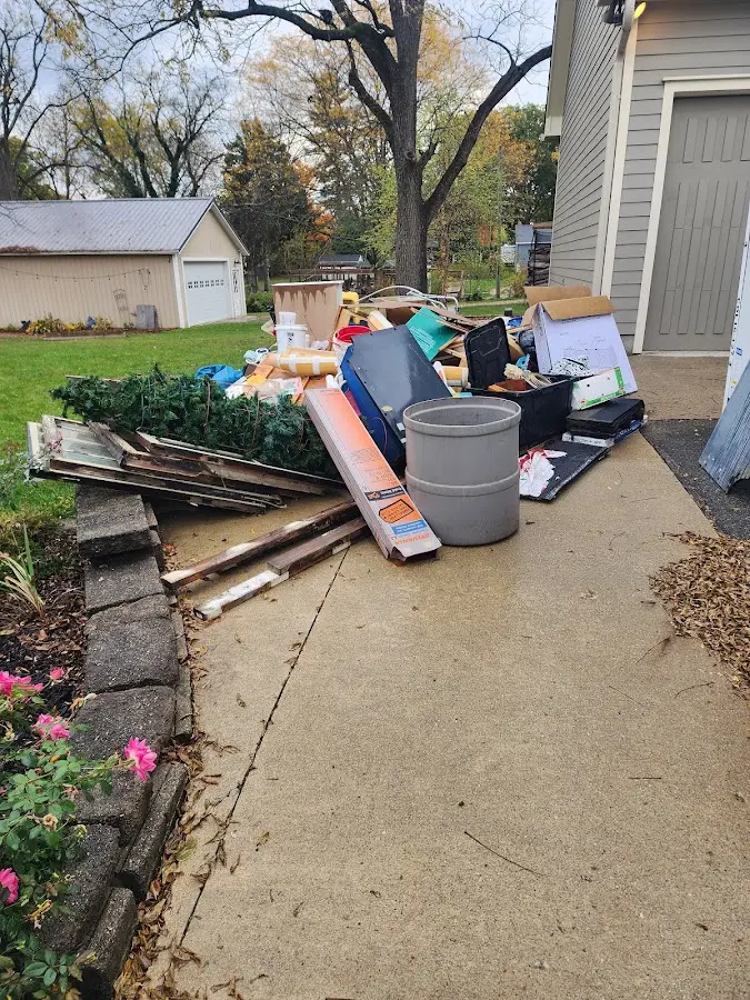 Dumpster being loaded with debris for 3 Yard Dumpster Rental in Northbrook
